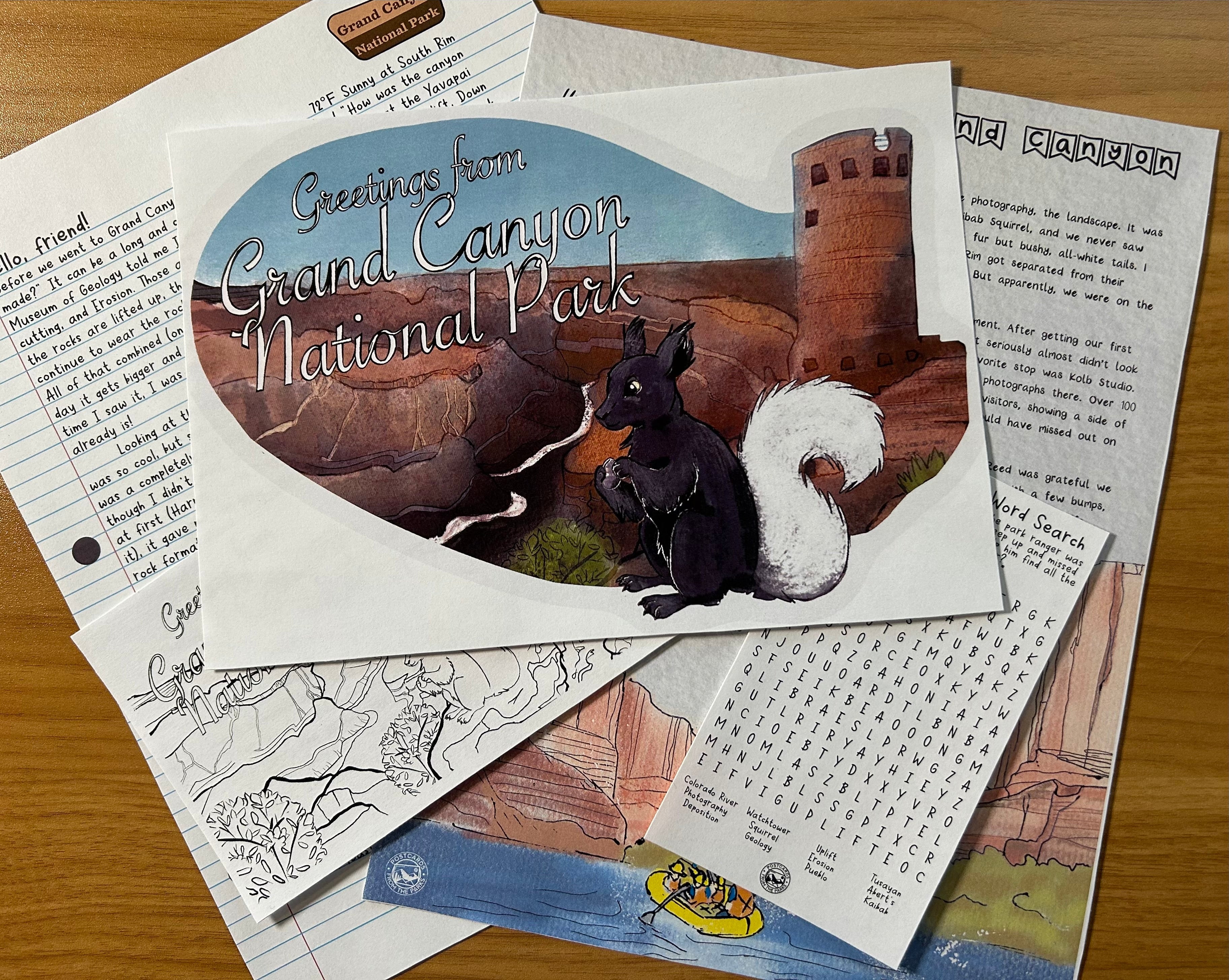 Postcard with Grand Canyon illustration on a stack of papers