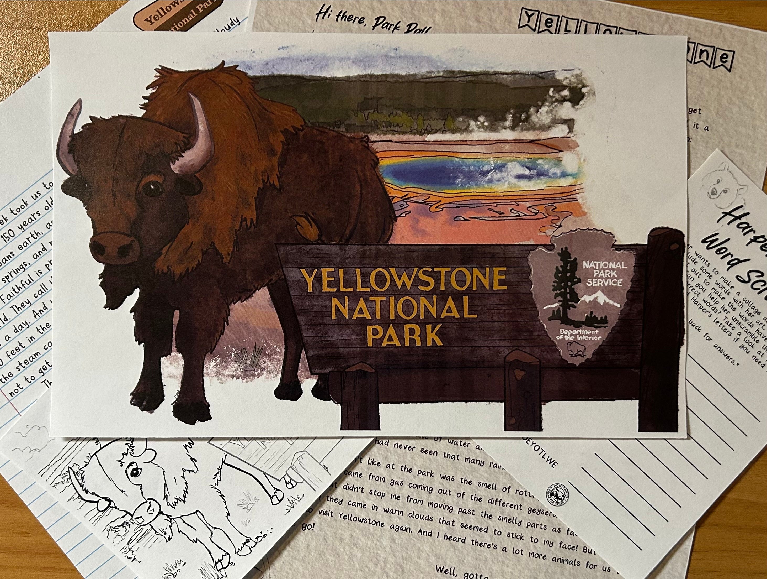 Postcard with a bear illustration and Yellowstone National Park sign on a textured surface.